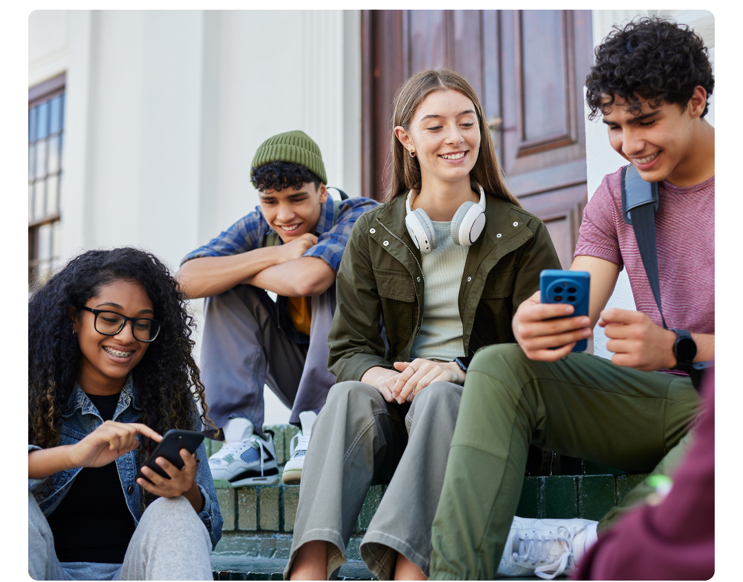 Four young adults sitting together outside