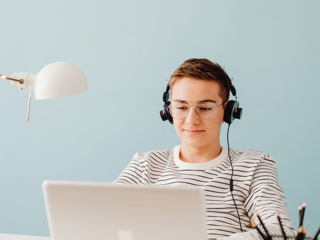 Young man sitting at a desk working on a computer