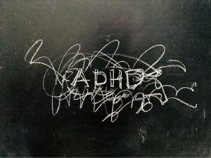 ADHD scribbled on a blackboard with chalk
